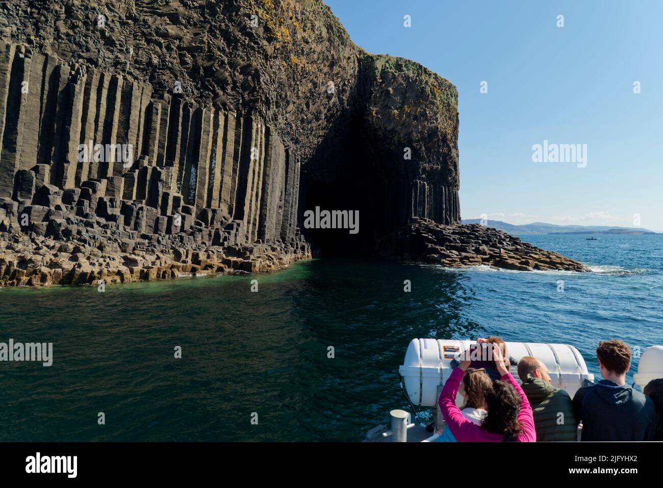 Staffa tour boat approaching Fingals Cave, Isle of Staffa Stock Photo