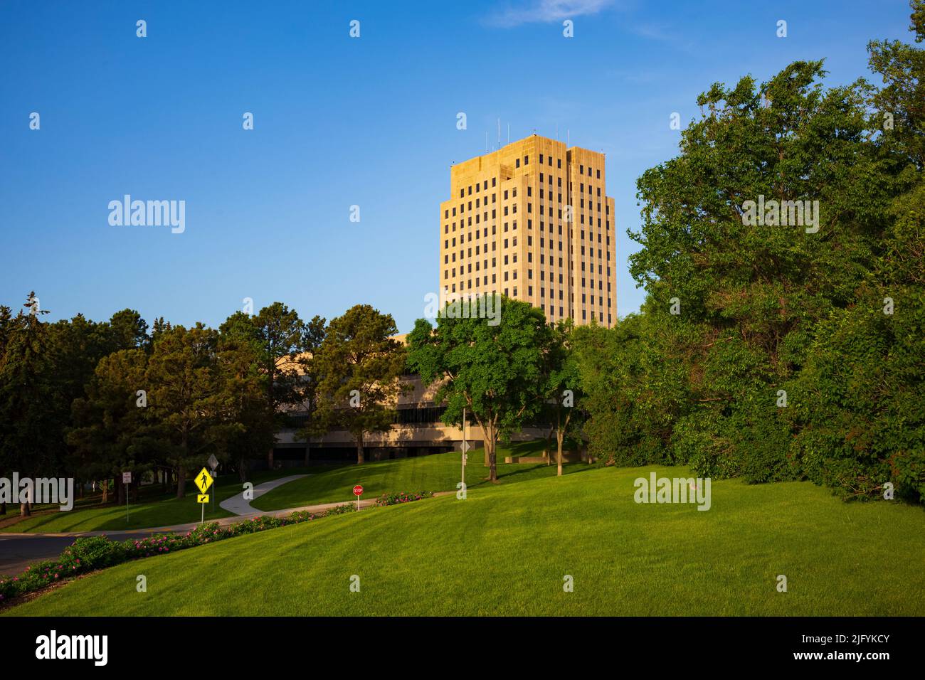 The North Dakota State Capitol, pictured here from the Capitol Grounds Native Prairie at Bismarck, is a 21-story Art Deco tower that is the tallest ha Stock Photo