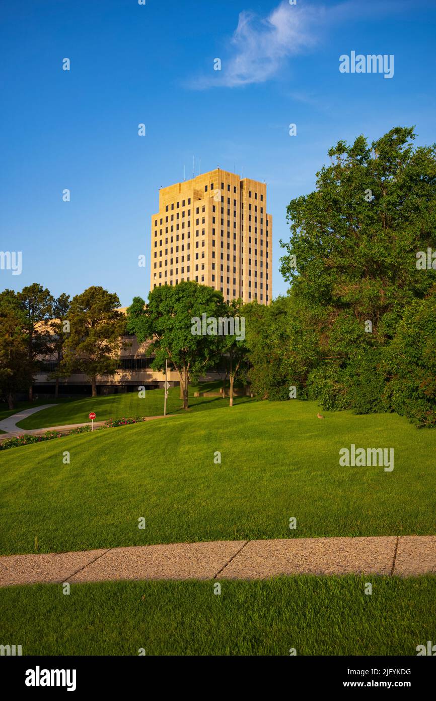 The North Dakota State Capitol, pictured here from the Capitol Grounds Native Prairie at Bismarck, is a 21-story Art Deco tower that is the tallest ha Stock Photo