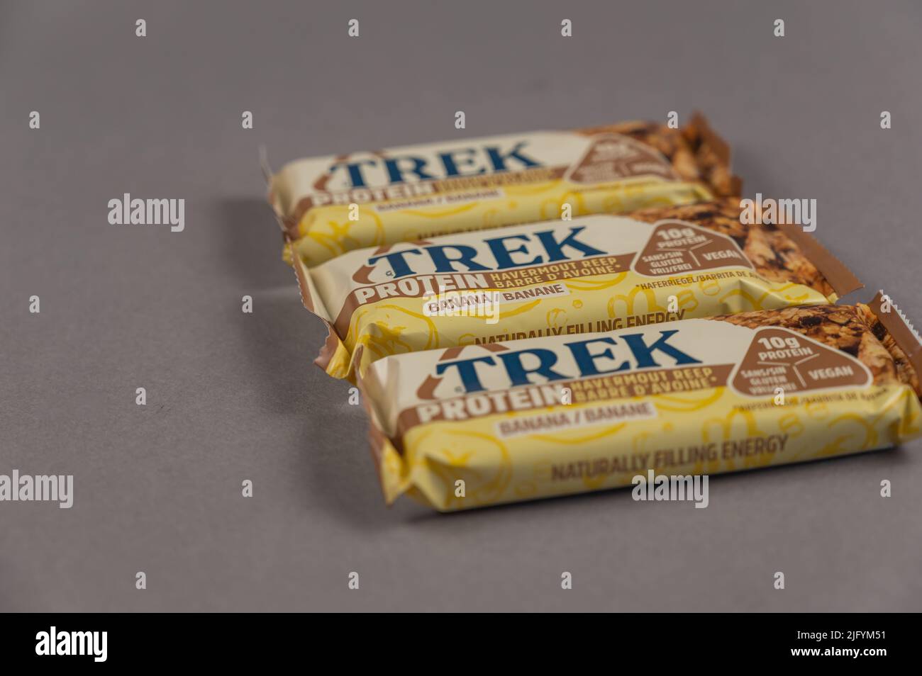 Three TREK Protein Energy Bars on Gray. A glutenfree, sugarfree snack