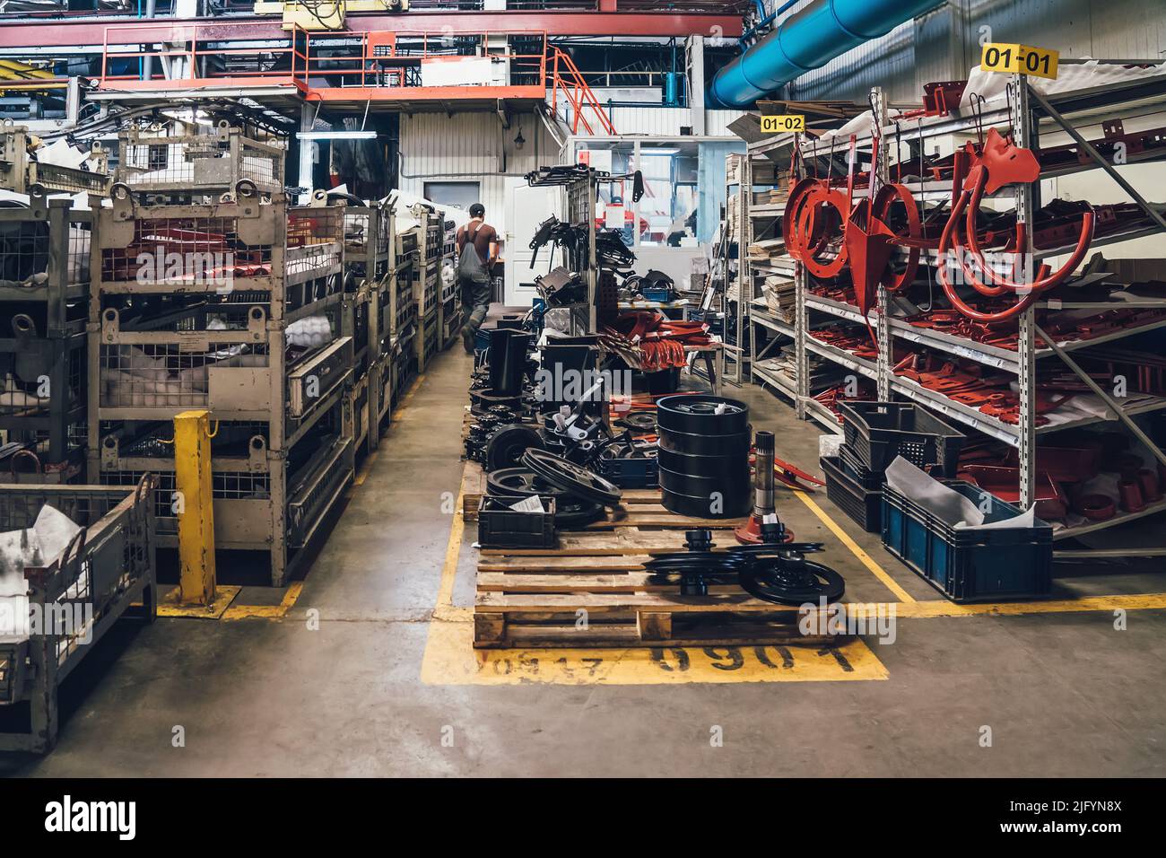 Components for agricultural machinery in warehouse of plant for