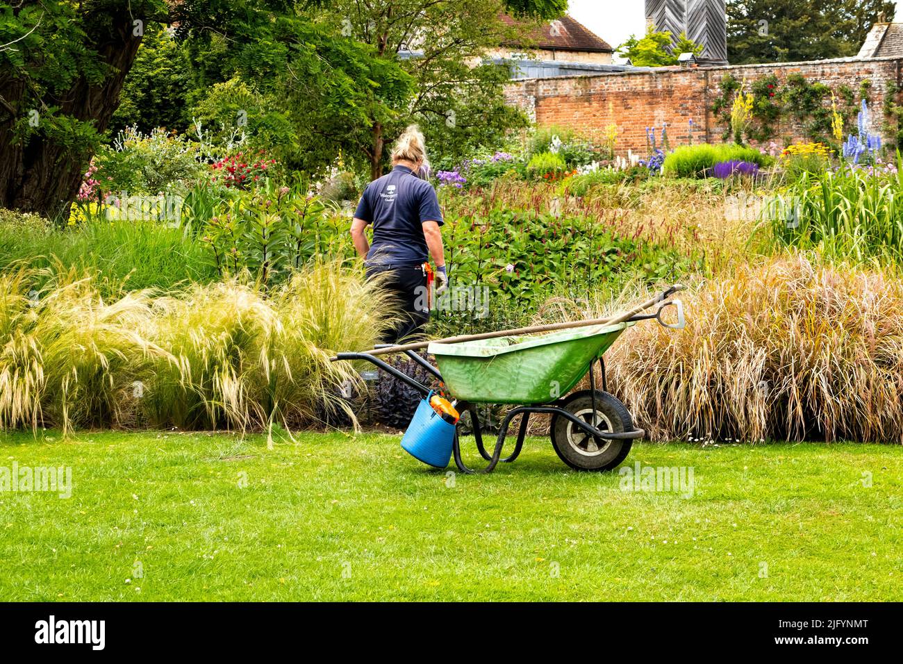 Gardener at Waterperry garden near Oxford UK in summer Stock Photo