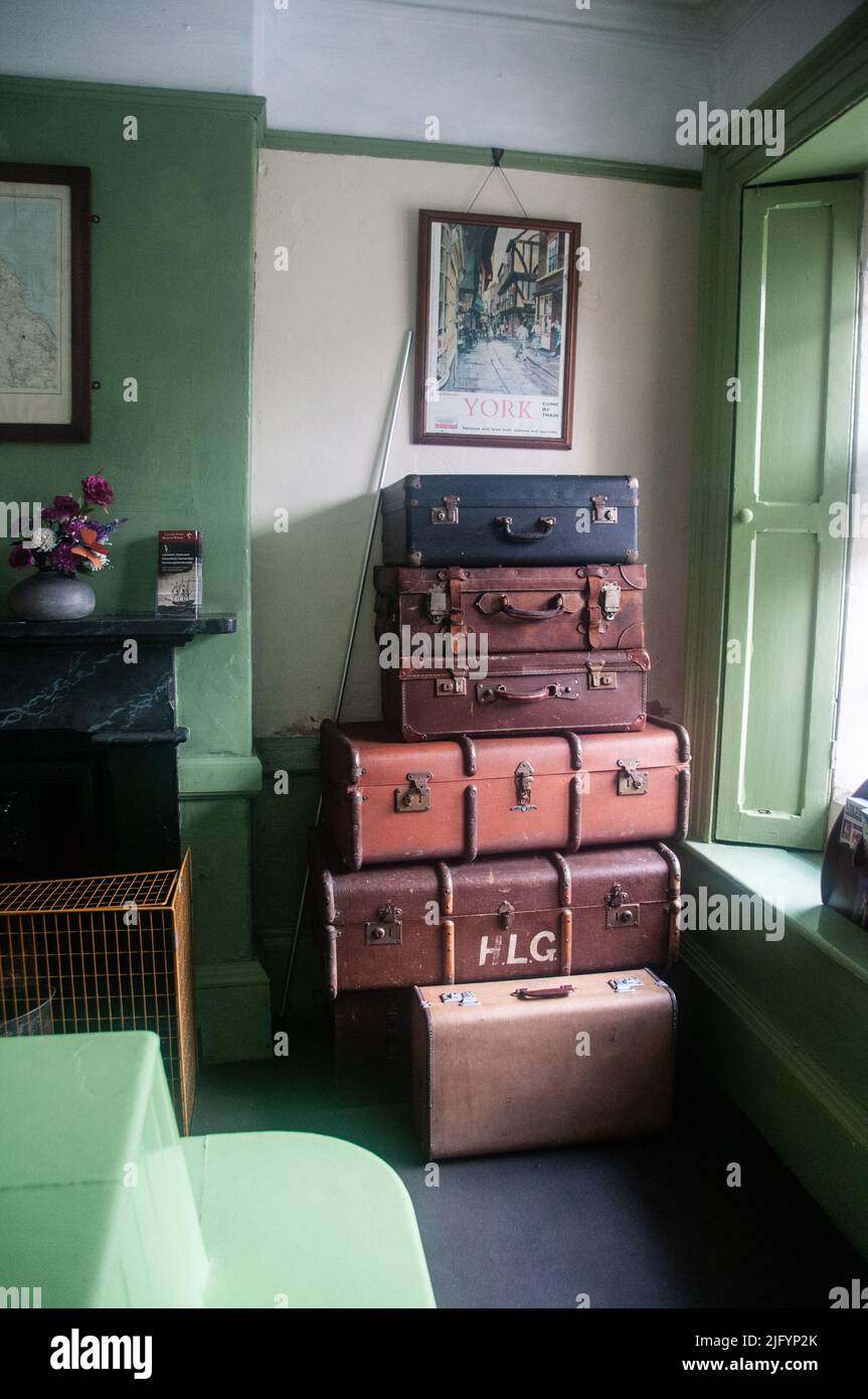 Around the UK - Display luggage piled up in the waiting room at Grosmont  Heritage Railway Station - North Yorkshire, UK Stock Photo
