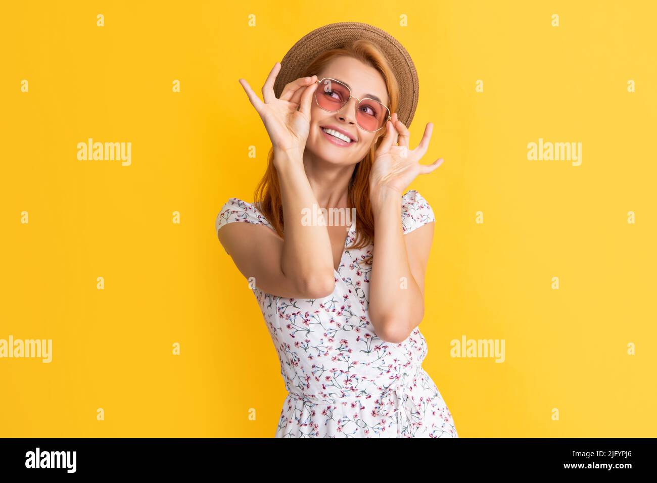 happy woman in straw hat and sunglasses on yellow background Stock ...