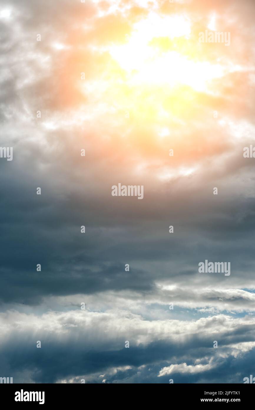 Thunderclouds with breaking rays sun at sunset Stock Photo
