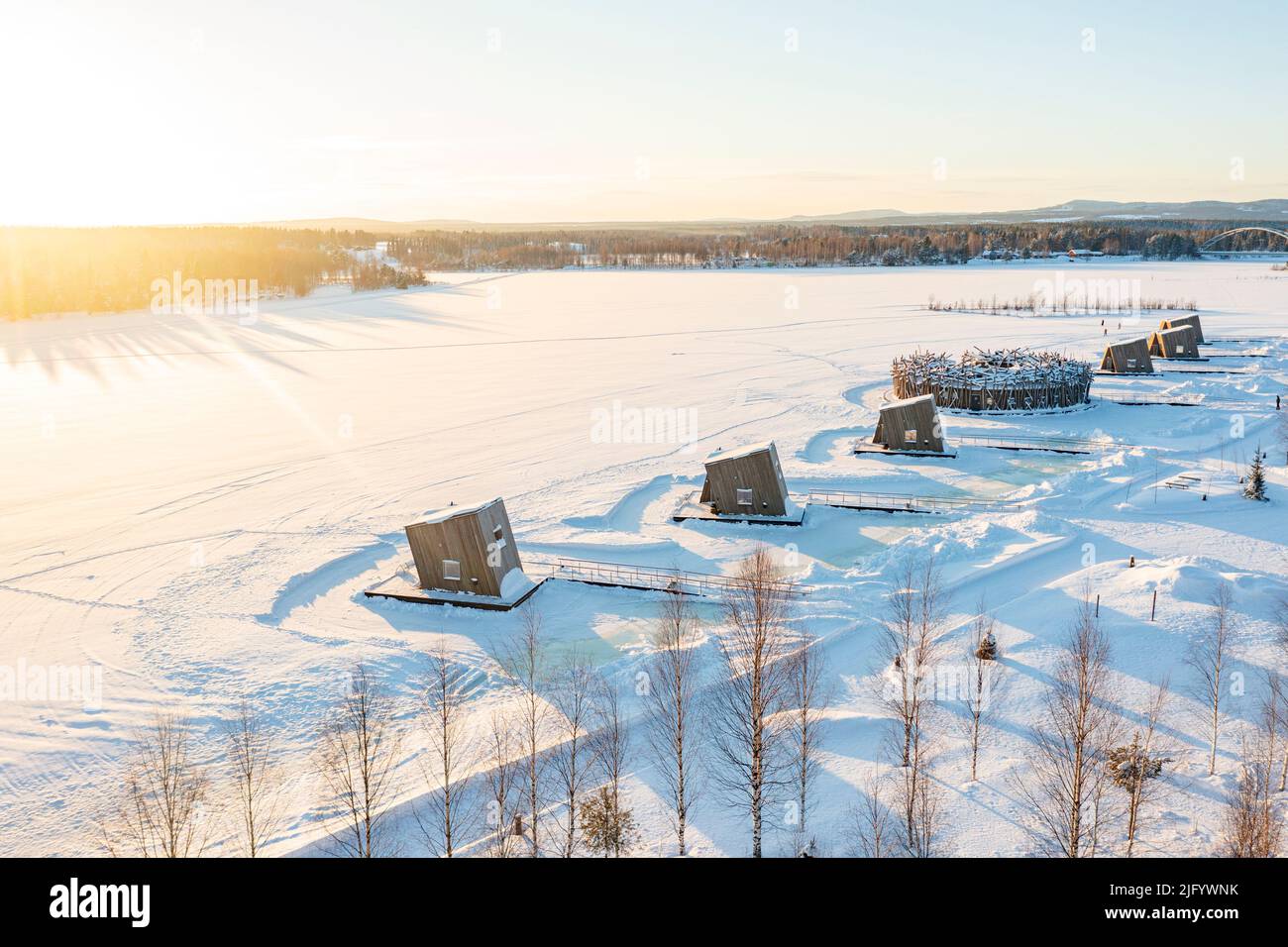Wooden cabins rooms of the luxury Arctic Bath Spa Hotel floating on frozen river Lule covered with snow, Harads, Lapland, Sweden, Scandinavia, Europe Stock Photo