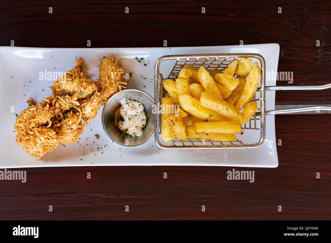 Overhead view of crunchy fried coconut prawns with french fries in a tray, Antigua, Leeward Islands, West Indies, Caribbean, Central America Stock Photo