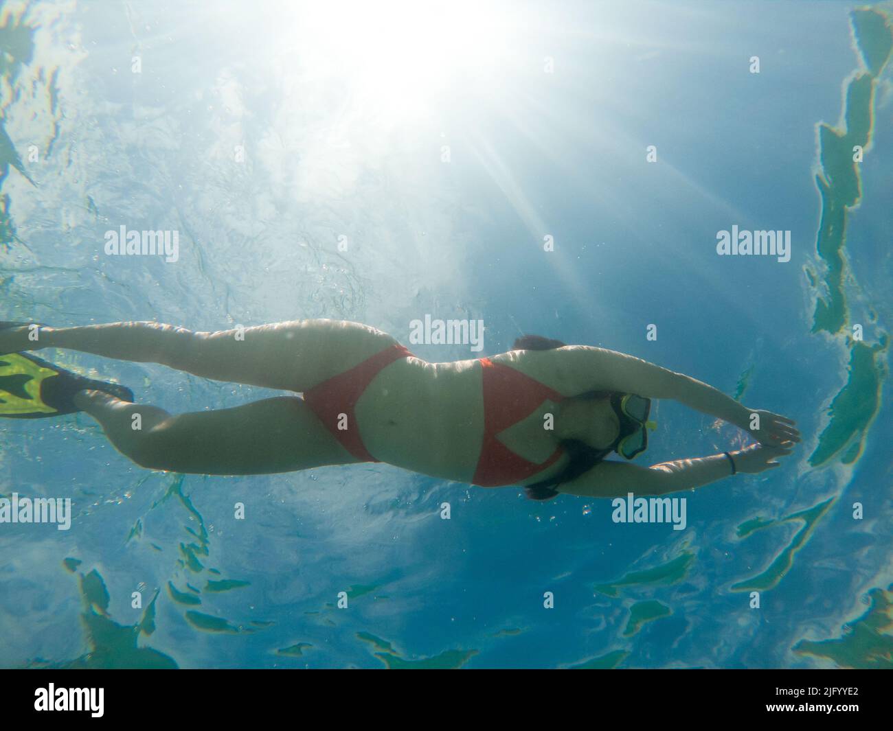 woman diving underwater in scuba mask and flippers underwater Stock