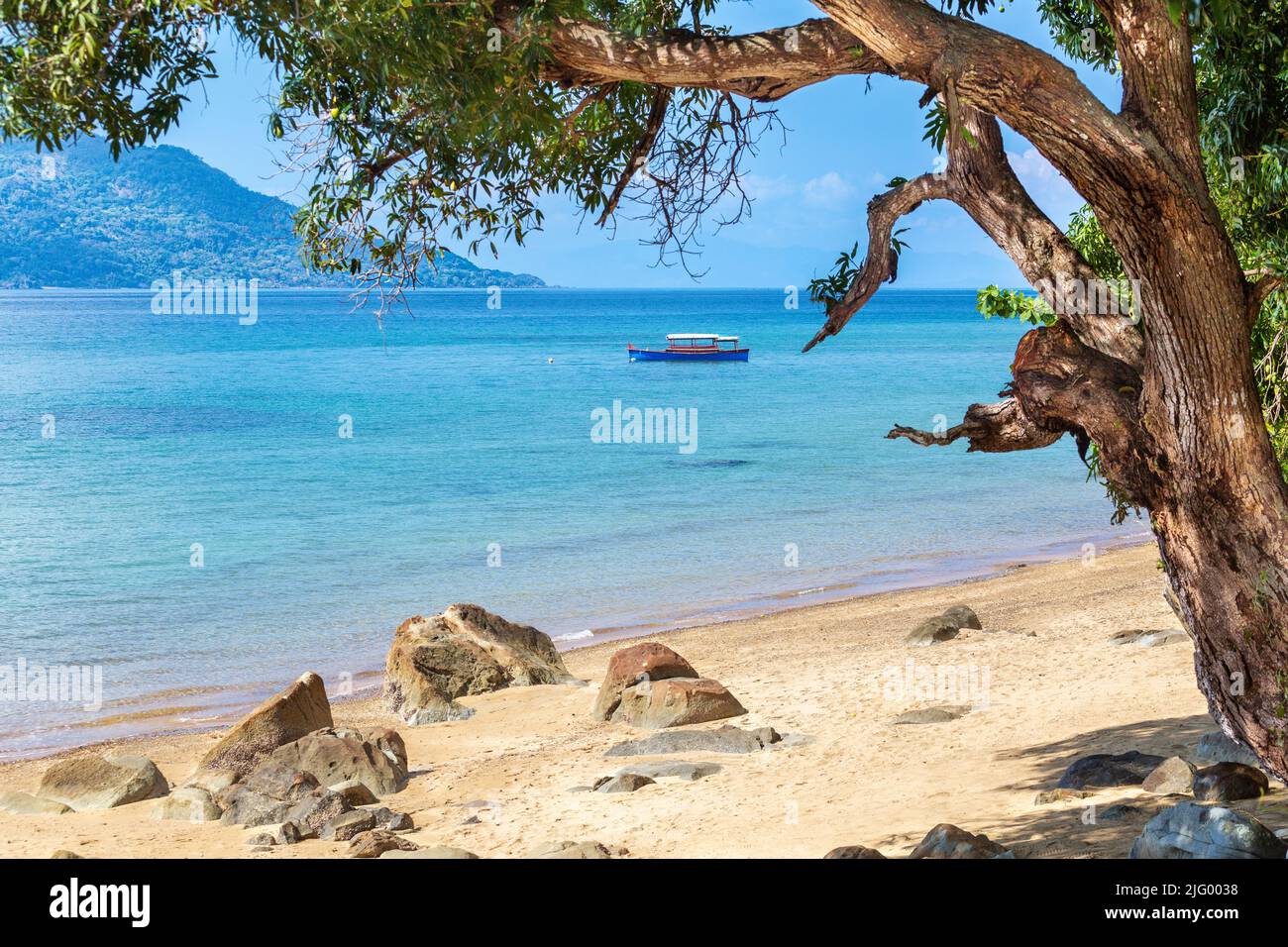 Boat anchored off the beach at Nosy Komba island, North West Madagascar, Indian Ocean, Africa Stock Photo