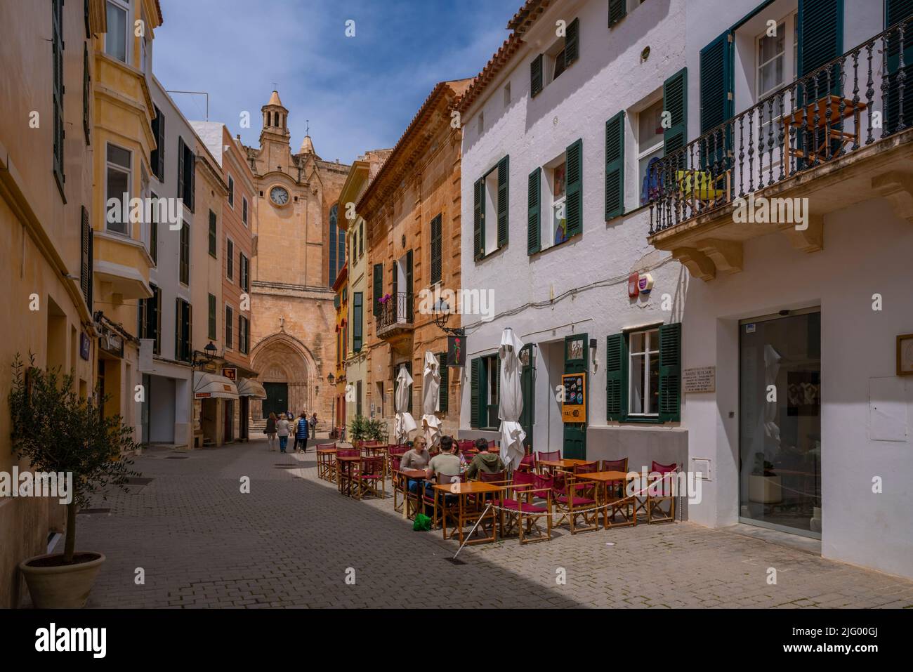 View of cafe in street and cathedral in background, Ciutadella, Menorca, Balearic Islands, Spain, Mediterranean, Europe Stock Photo