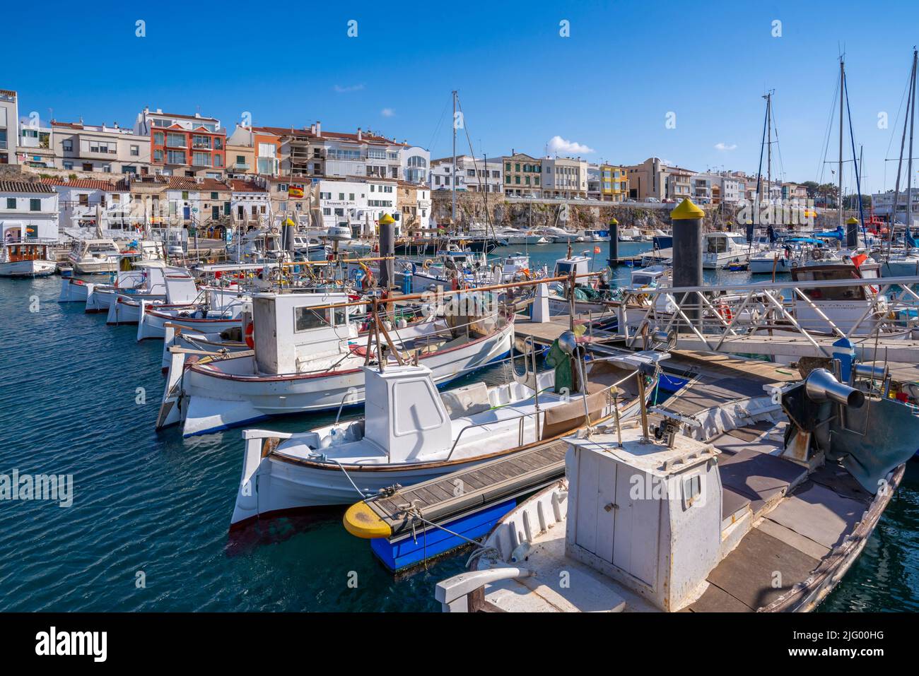 View of boats in marina overlooked by whitewashed houses, Ciutadella, Menorca, Balearic Islands, Spain, Mediterranean, Europe Stock Photo