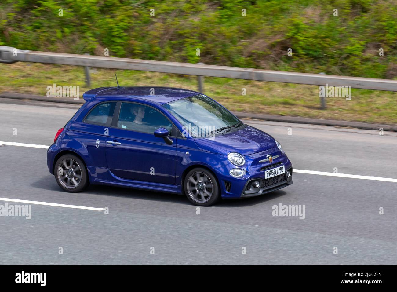 2019 blue Abarth 595 T-Jet 145 1368cc petrol hatchback; driving on the M6 Motorway, Manchester, UK Stock Photo