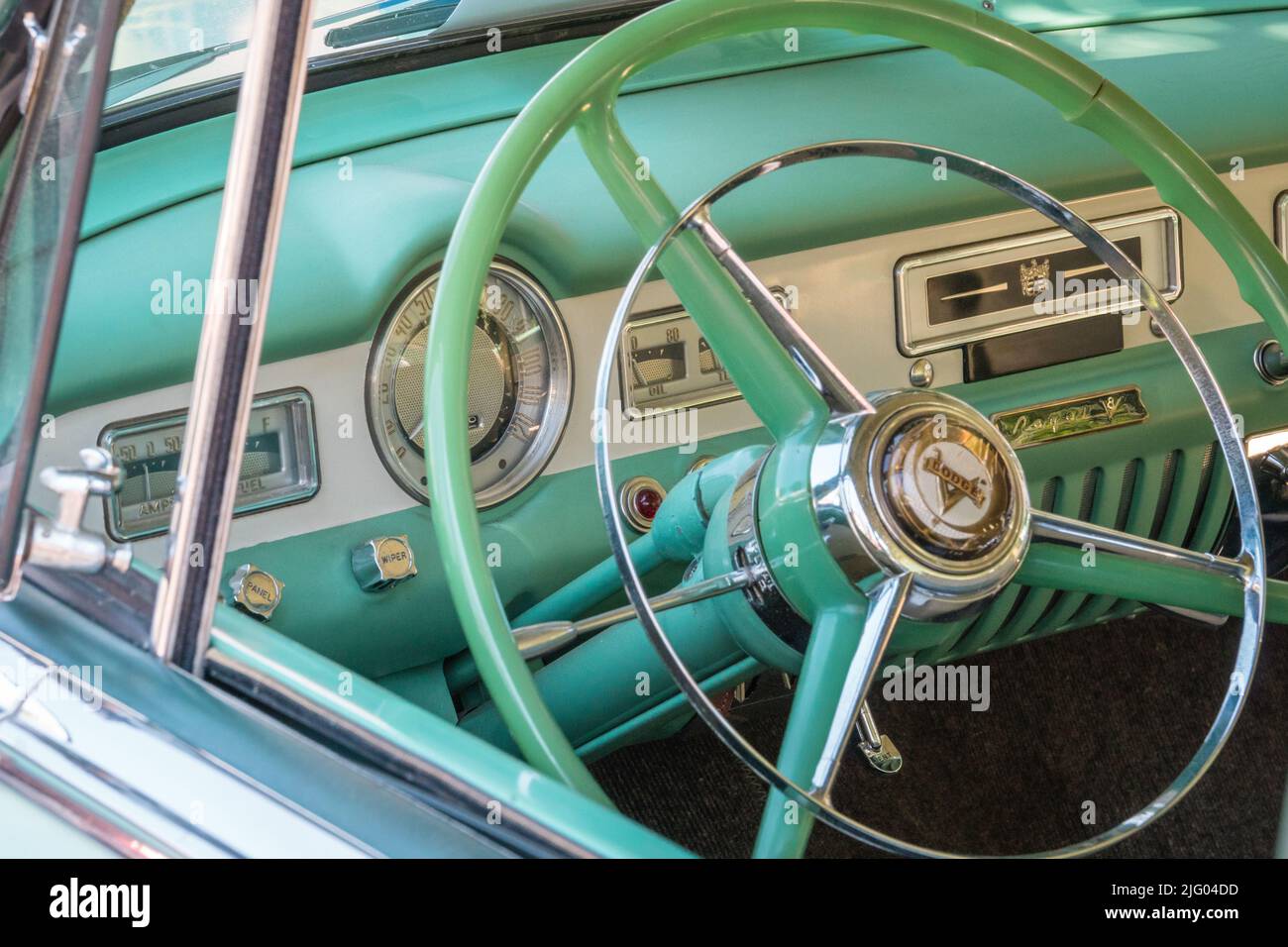Andover, MA, US-June 26, 2022: Close-up view of the steering wheel in a pastel green 1950s - 1960s era Dodge classic car. Stock Photo