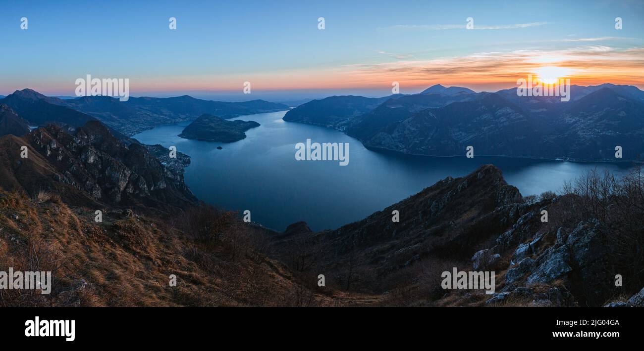 View of Lake Iseo at sunset, with the alps framing it, near the town of Zone, Italy - February 2022. Stock Photo