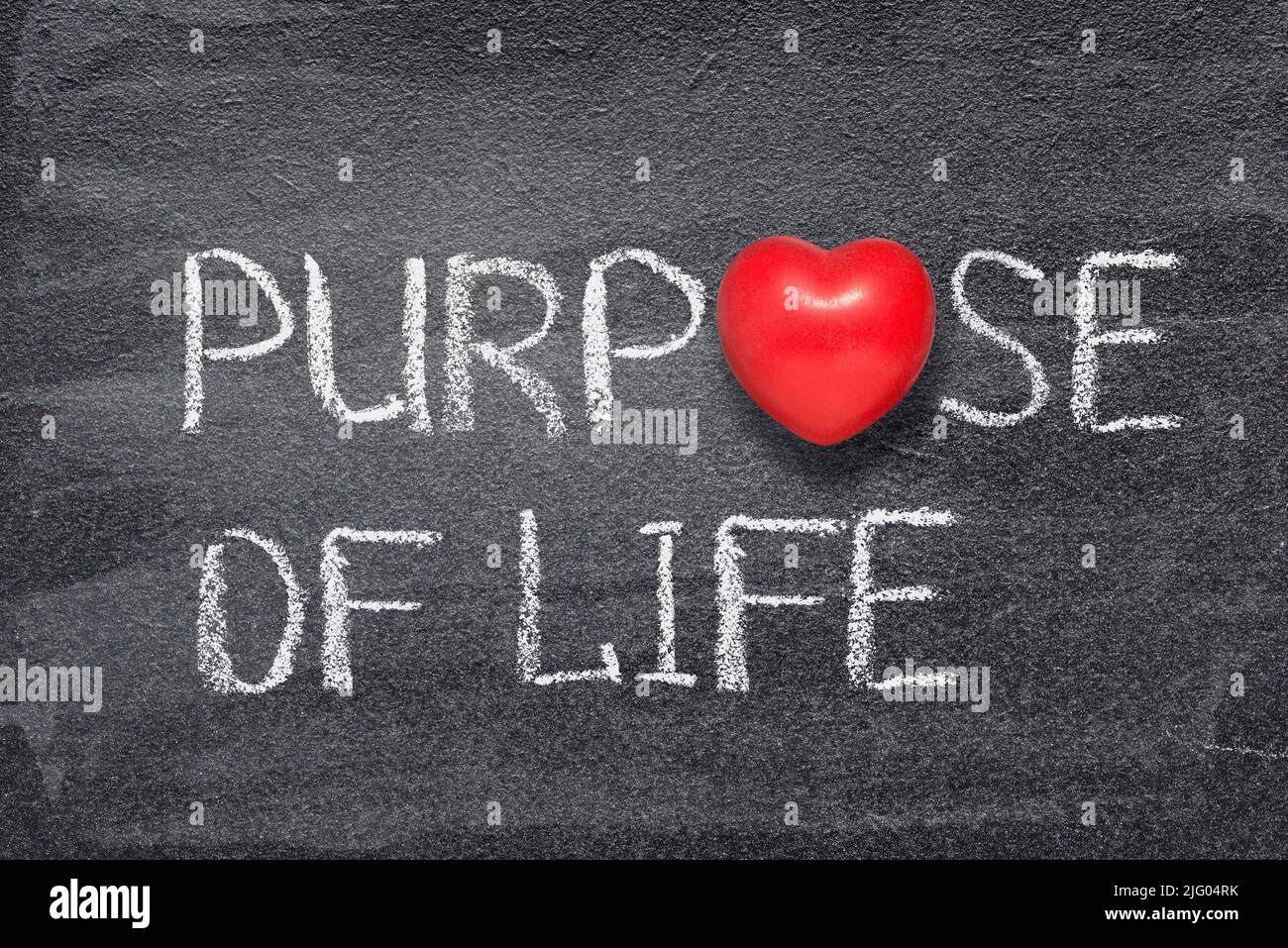 purpose of life phrase written on chalkboard with red heart symbol