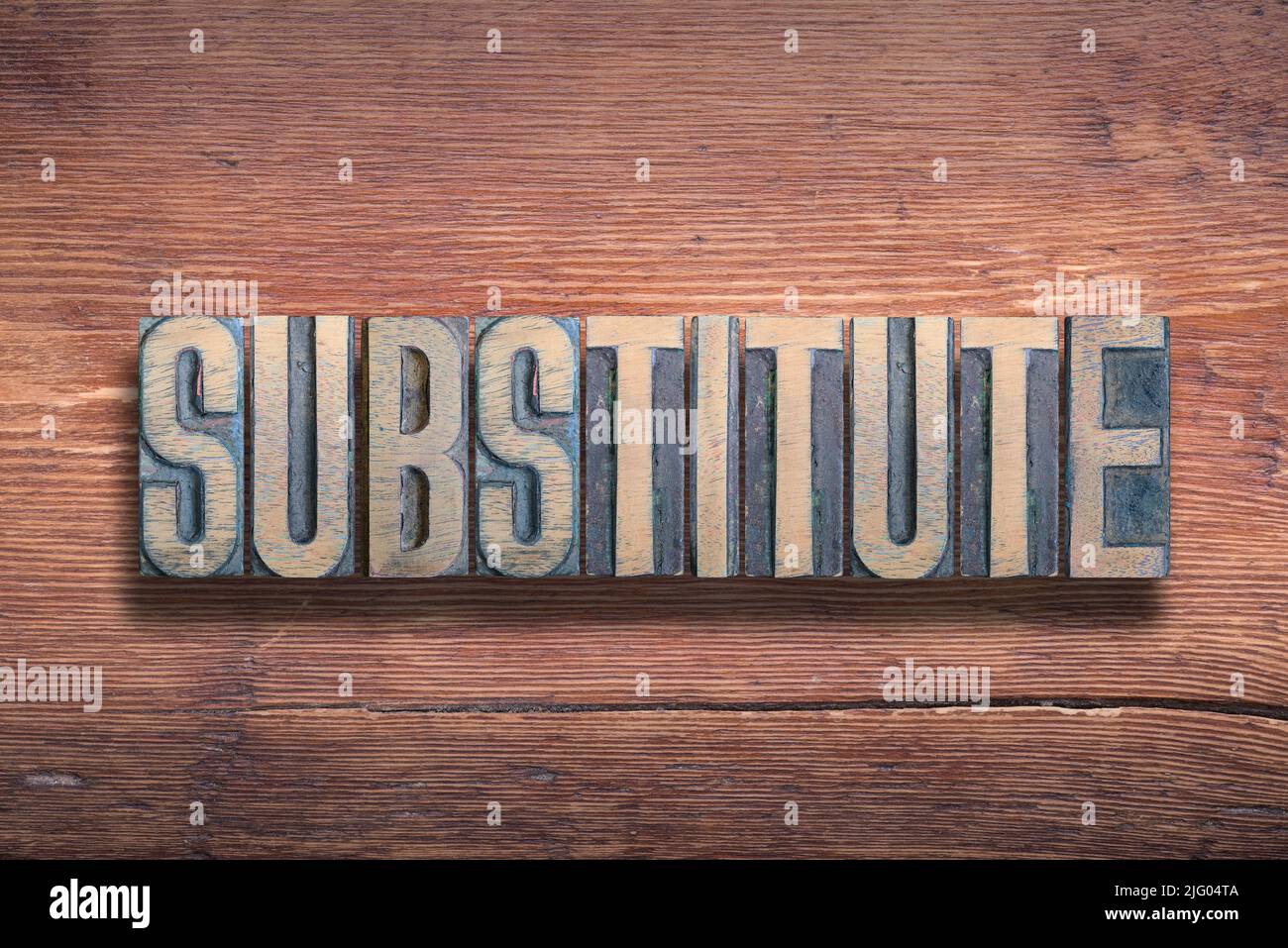 substitute word combined on vintage varnished wooden surface Stock Photo