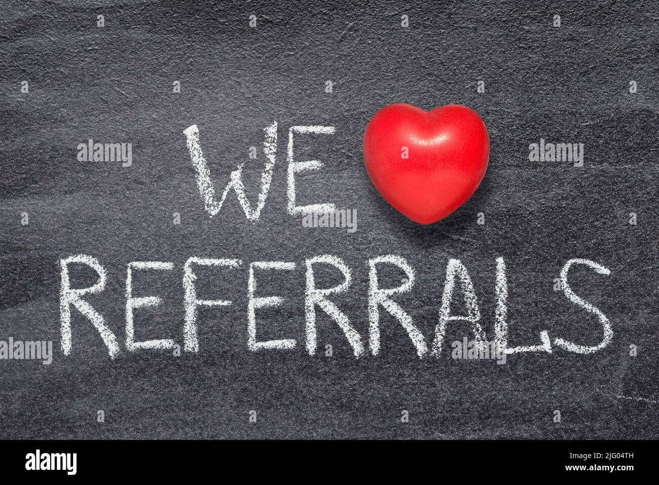 we love referrals phrase written on chalkboard with red heart symbol Stock Photo