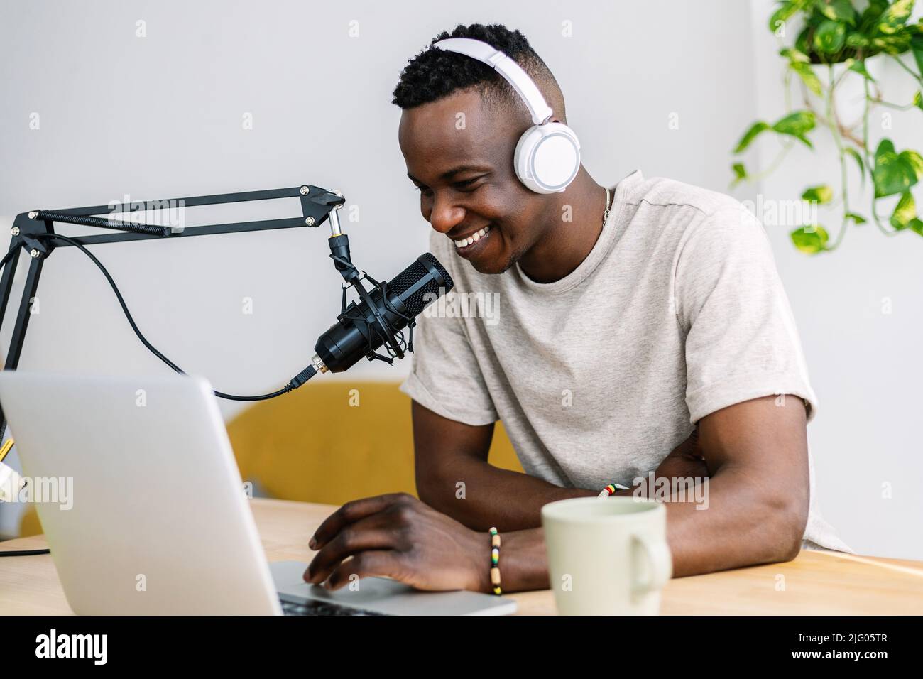 Young african creator man recording radio content for his blog at home studio Stock Photo