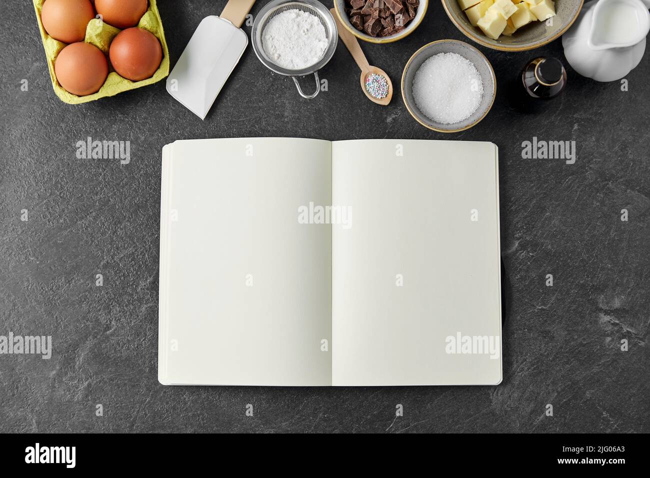 recipe book and cooking ingredients on table Stock Photo