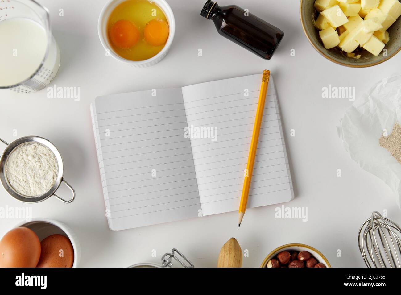 recipe book and cooking ingredients on table Stock Photo