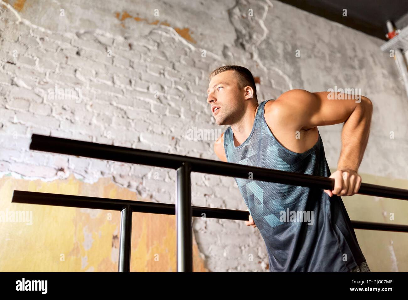 man doing triceps dip on parallel bars in gym Stock Photo Alamy