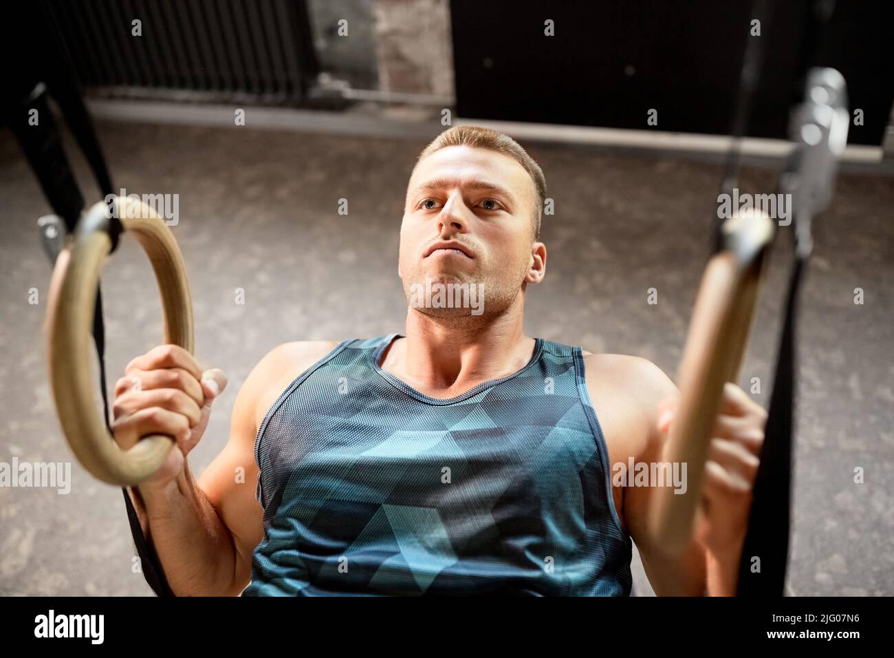 Woman holding gymnastic rings in gym