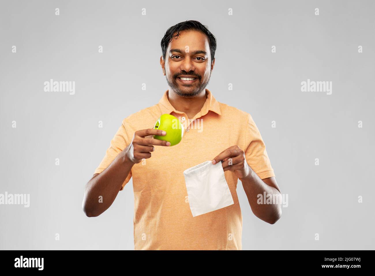 indian man with apple and reusable canvas bag Stock Photo - Alamy