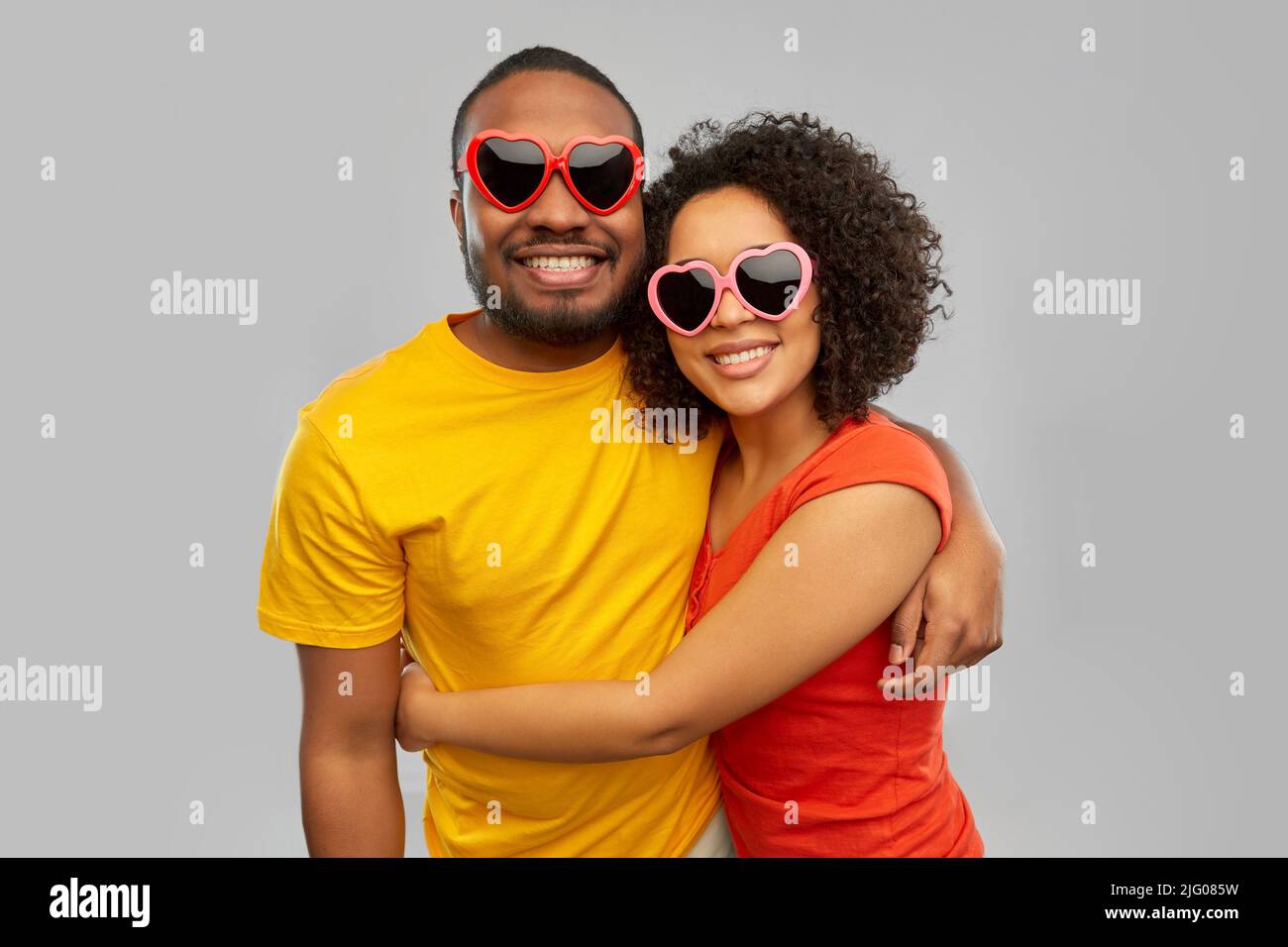 happy african couple in heart shaped suglasses Stock Photo - Alamy