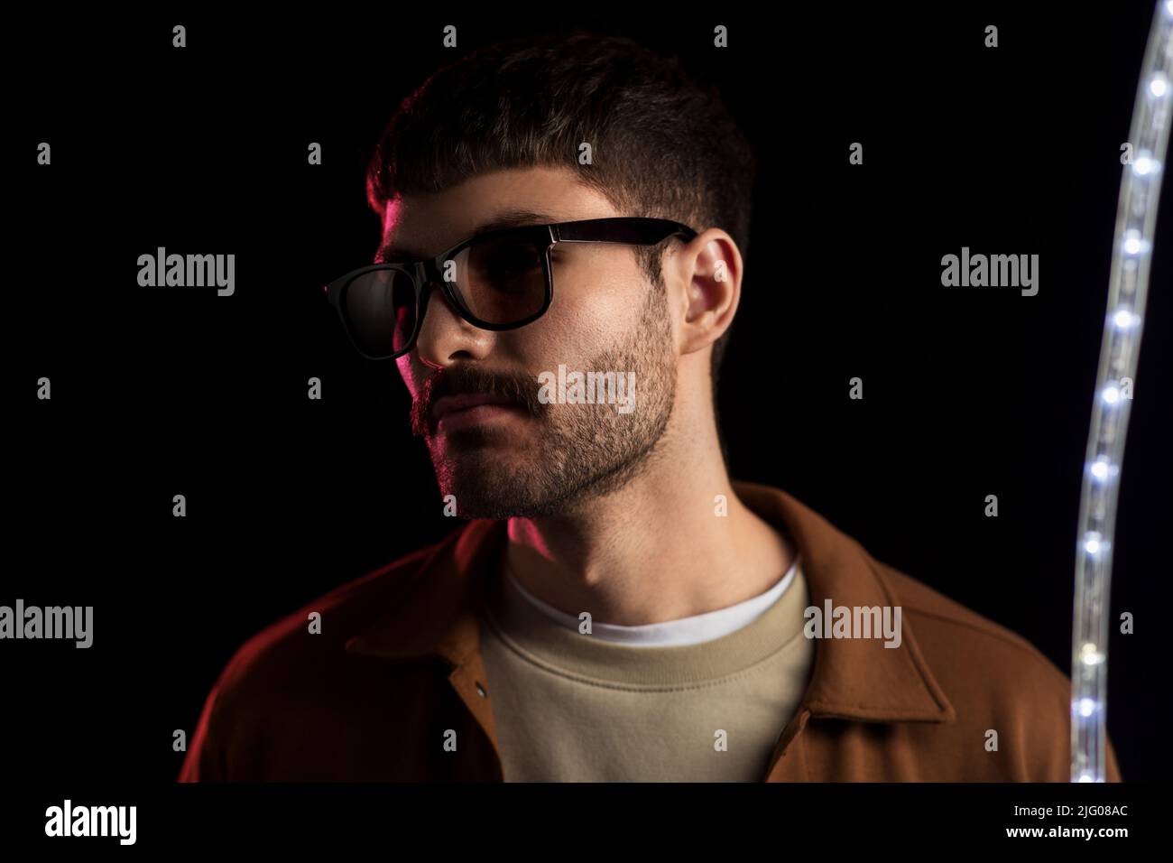 man in sunglasses over neon lights at Stock Photo Alamy