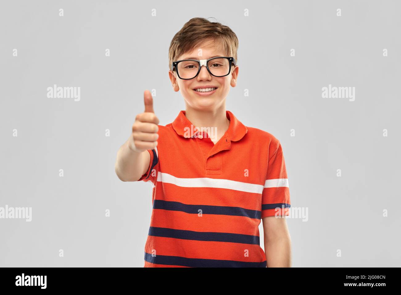happy smiling boy in eyeglasses showing thumbs up Stock Photo - Alamy
