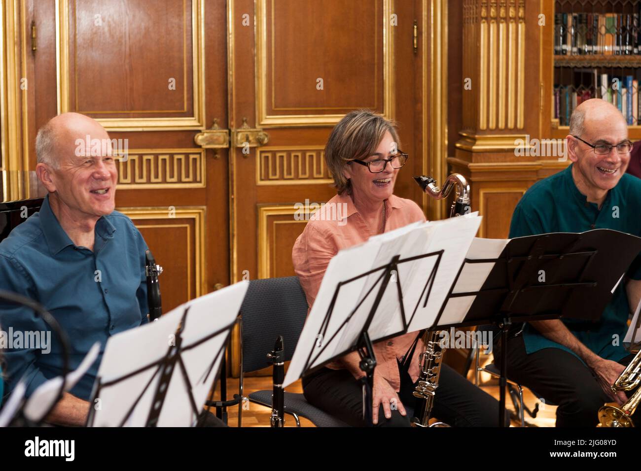 Musicians share a joke during a CoMA (Contemporary Music for All) rehearsal at West Dean Collage, 2019 Stock Photo
