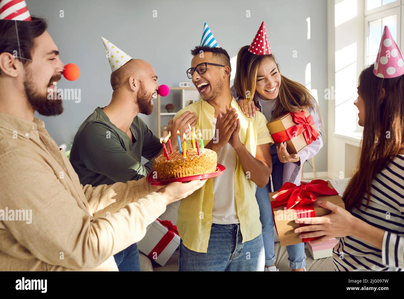 Happy diverse people greeting friend with birthday Stock Photo