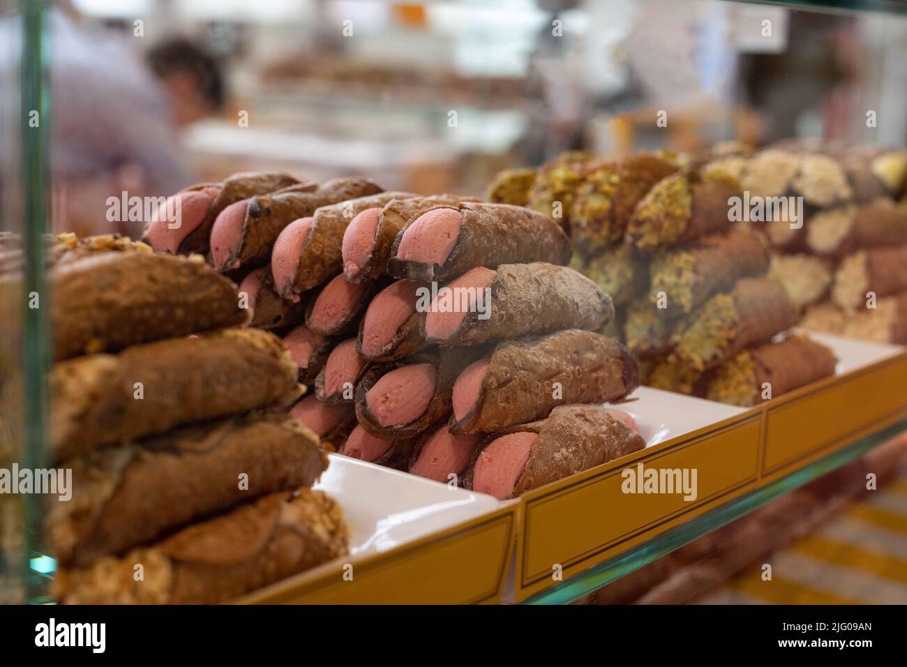 Italian Sweet Dessert, Traditional Sicilian Cannoli with Pink Cream Flavored with Orange. Stock Photo