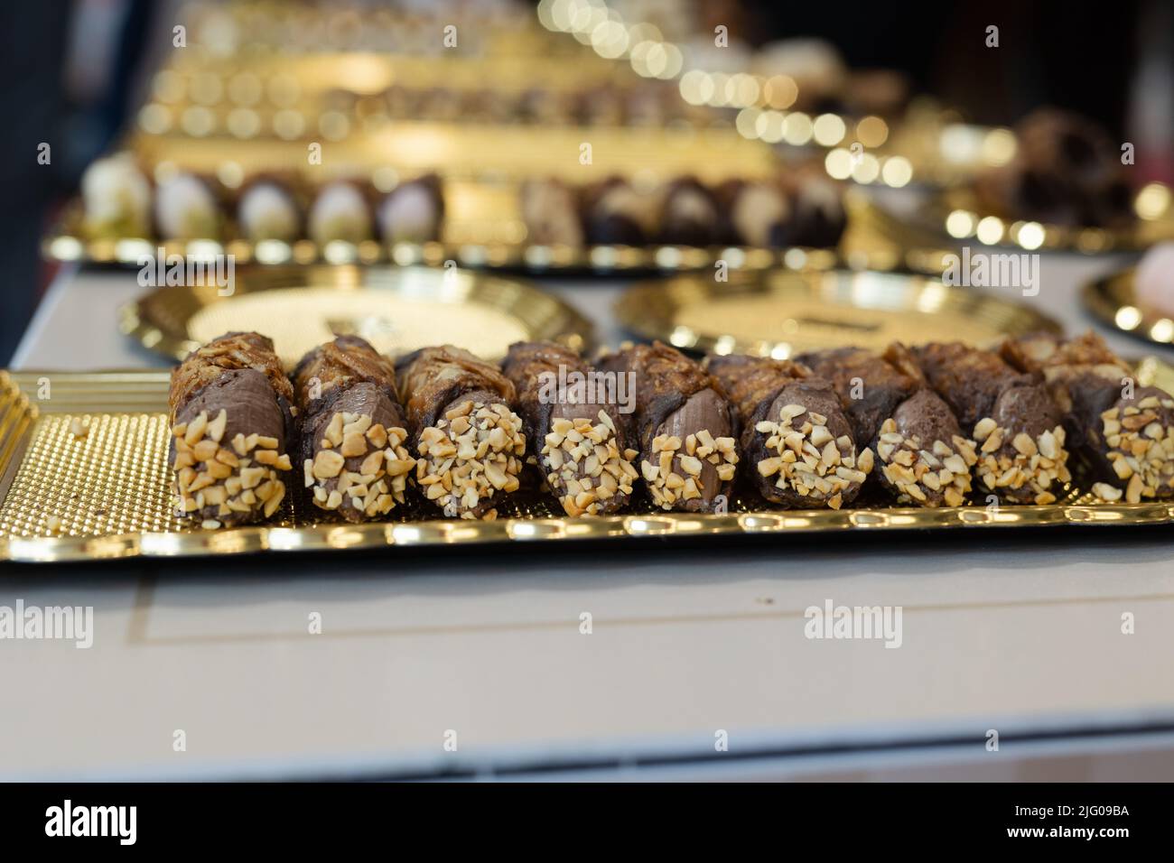 Italian Sweet Dessert, Traditional Sicilian Cannoli with Nuts and Chocolate Cream. Stock Photo