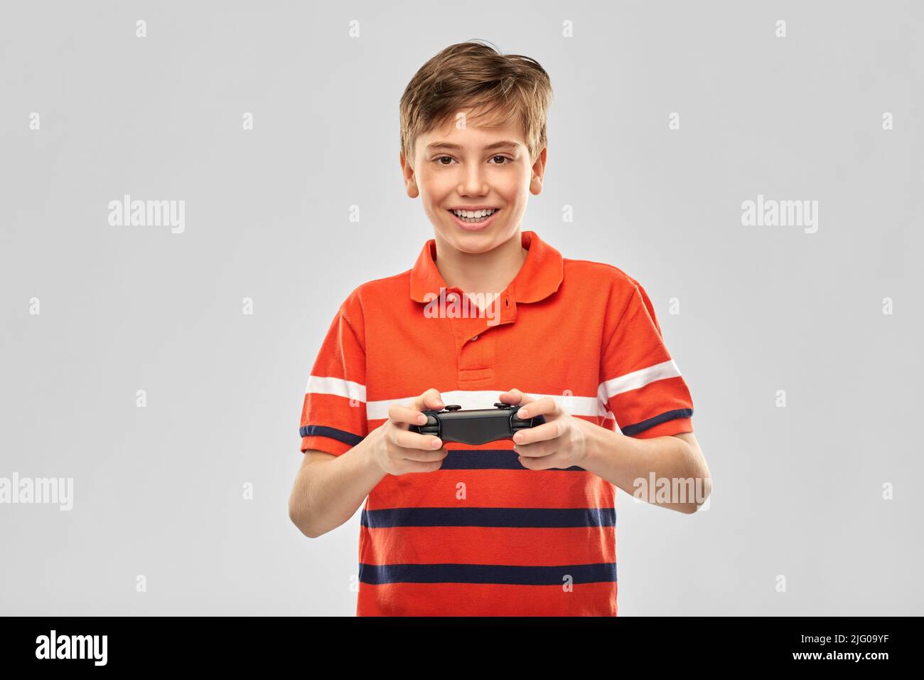 Boy smiling playing video game hi-res stock photography and images - Alamy