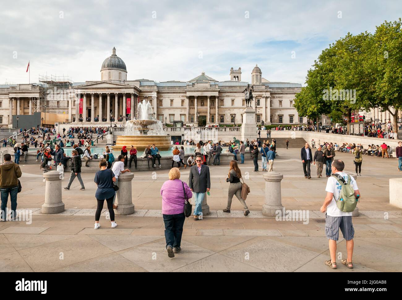London, United Kingdom - September 26, 2013: Crowd of people visiting the Trafalgar Square in central London, United Kingdom Stock Photo