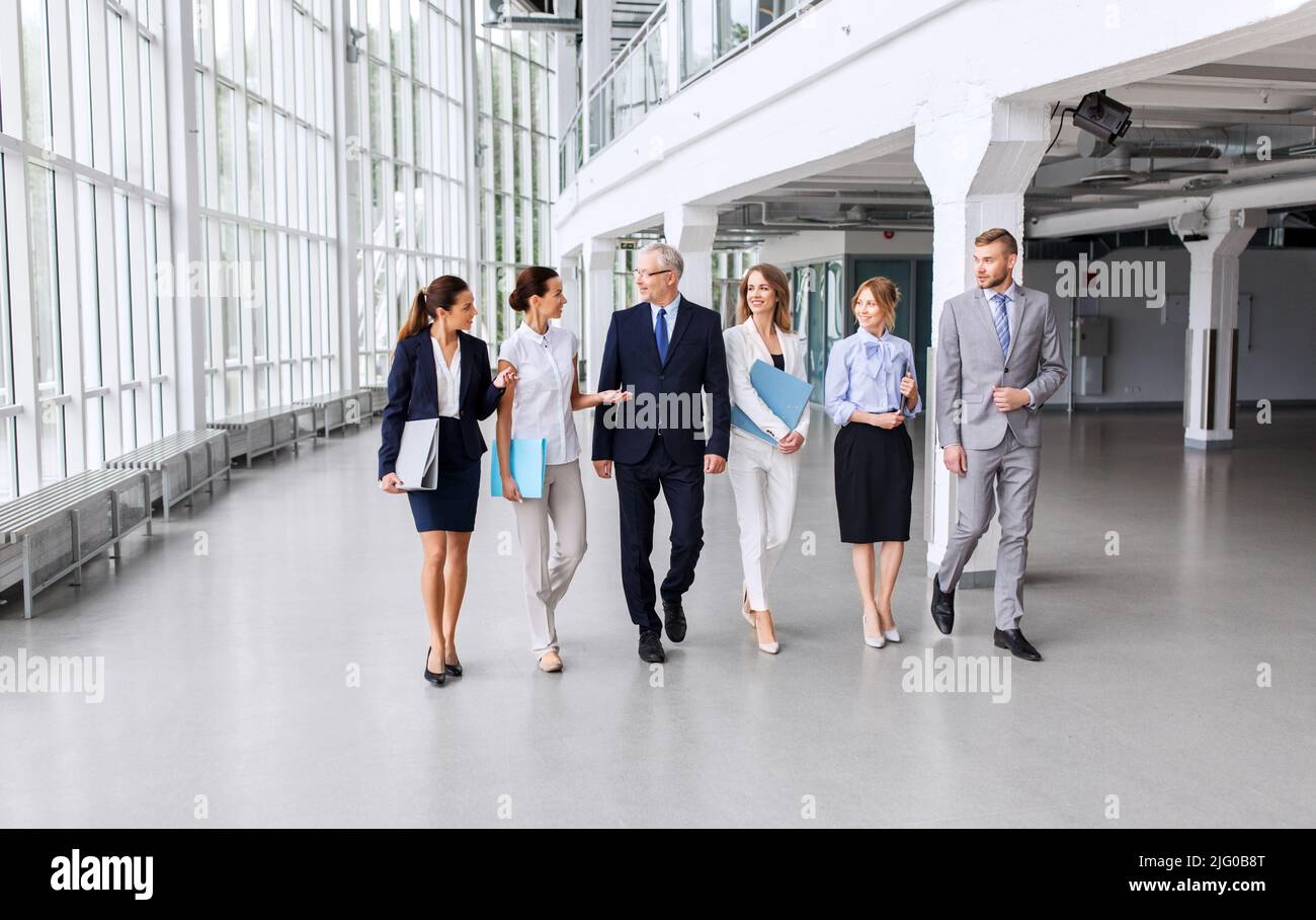 business people walking along office building Stock Photo - Alamy