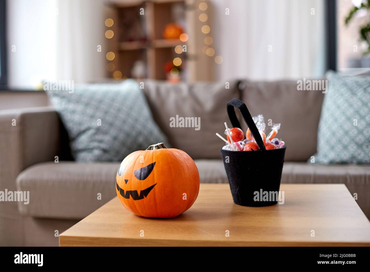 jack-o-lantern and candies at home on halloween Stock Photo
