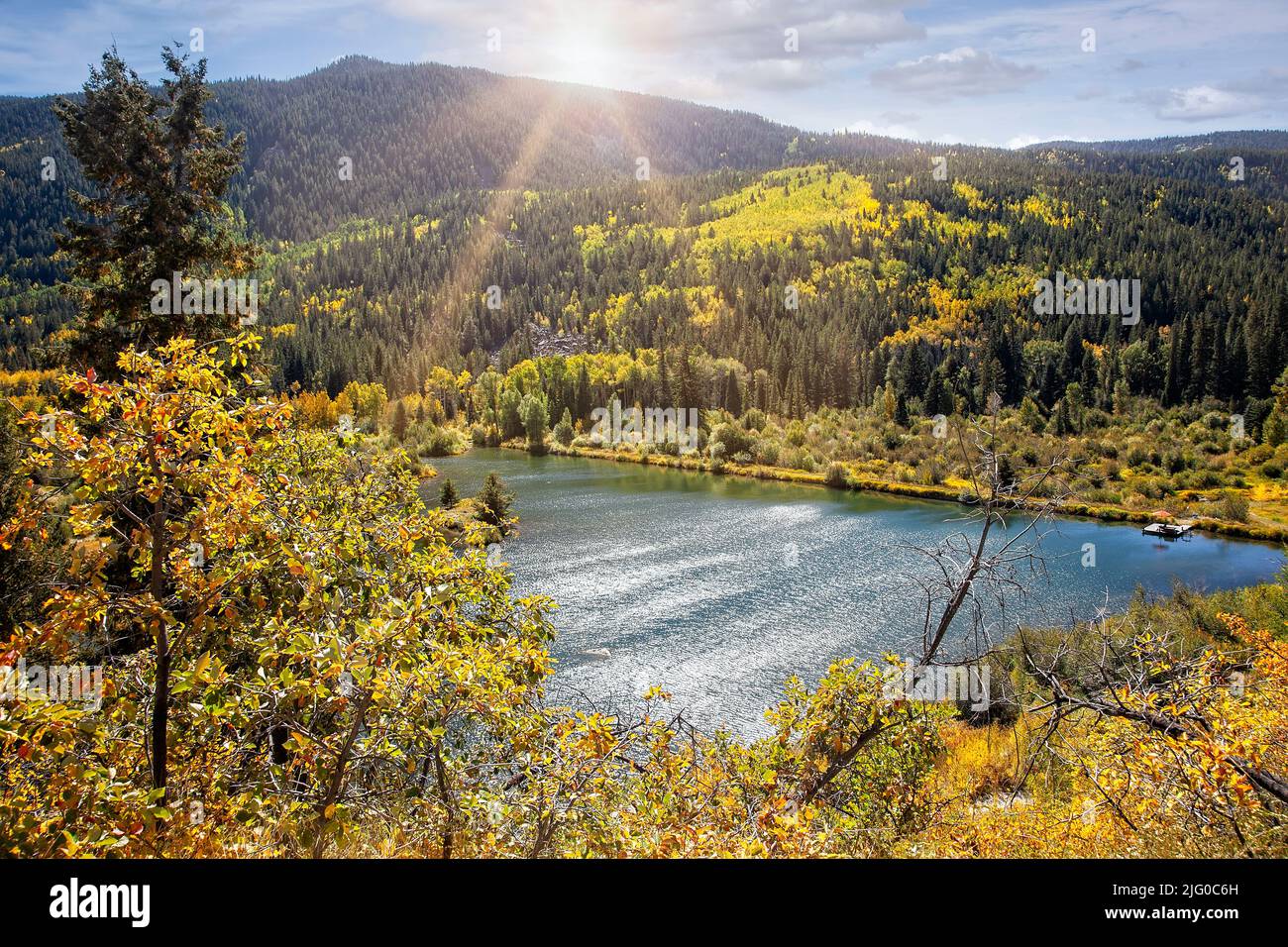 Sun Rays Over a Lake in colorful Autumn in Colorado Stock Photo