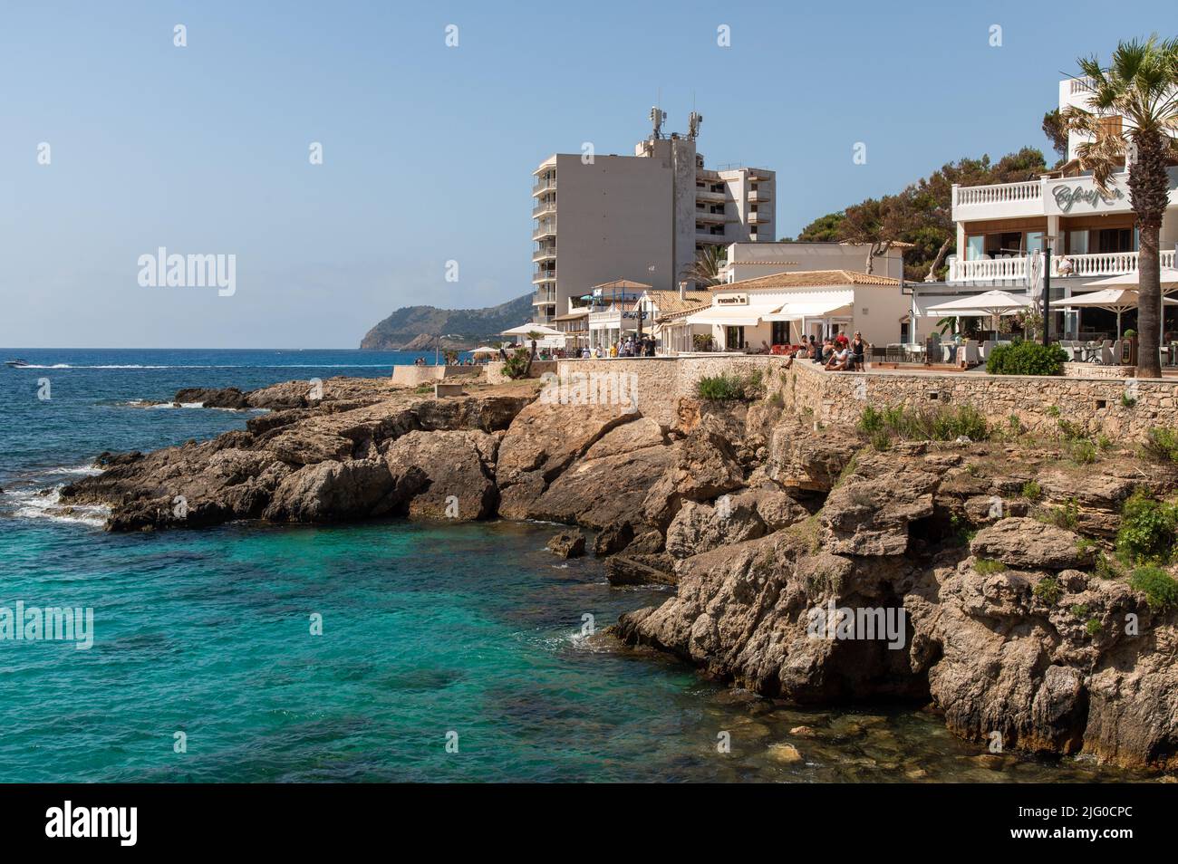 Cala Ratjada, Mallorca, Spain; June 25th, 2022: Rocky coastline on Cala Ratjada waterfront promenade Stock Photo