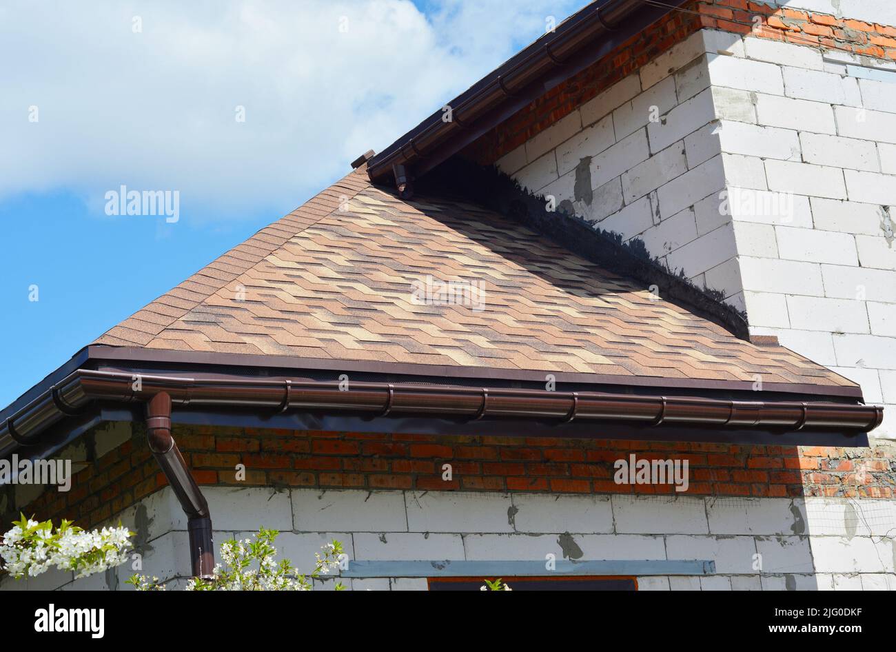 Asphalt shingles roofing construction. House asphalt shingles corner