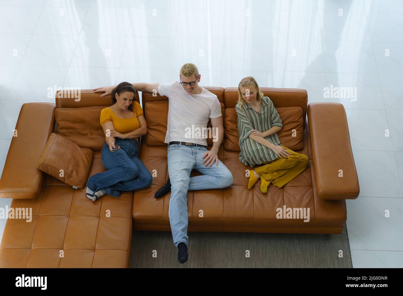 Top view of Caucasian happy family sitting and watching television in living room at home and spent quality time together for activity in vacation day Stock Photo
