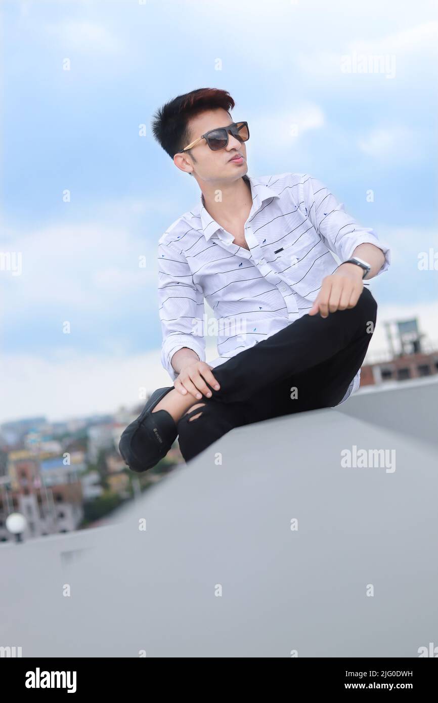Street fashion. Young fashionable man in full length guy with stylish  haircut casual clothes posing outdoor on cityspace background. Aged tone -  Stock Image - Everypixel