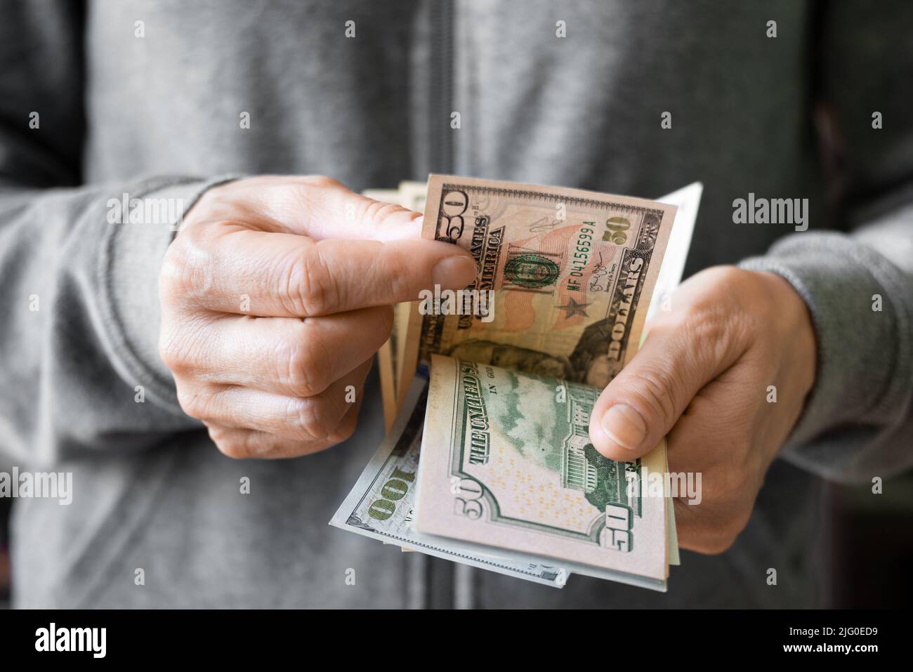 White female count US dollar bills bills in her hands Stock Photo