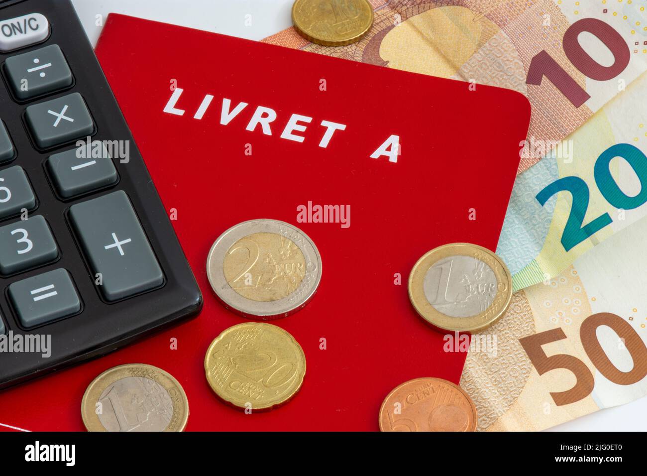 France: Livret A booklet with euro cash and a calculator. The Livret A is a regulated French savings account Stock Photo