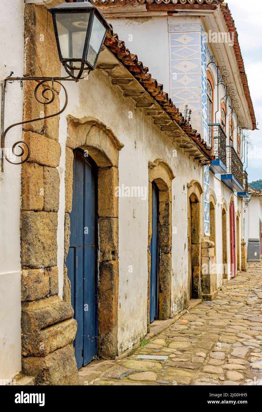 Facades of old colonial-style houses and cobblestone street in the historic city of Paraty on the south coast of Rio de Janeiro Stock Photo