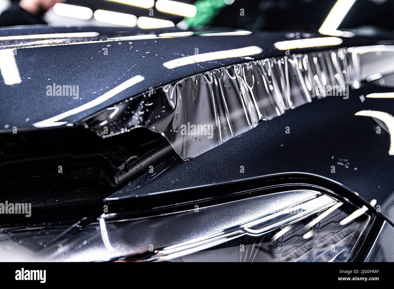 Hood of a modern car during the application of a tranparent protective