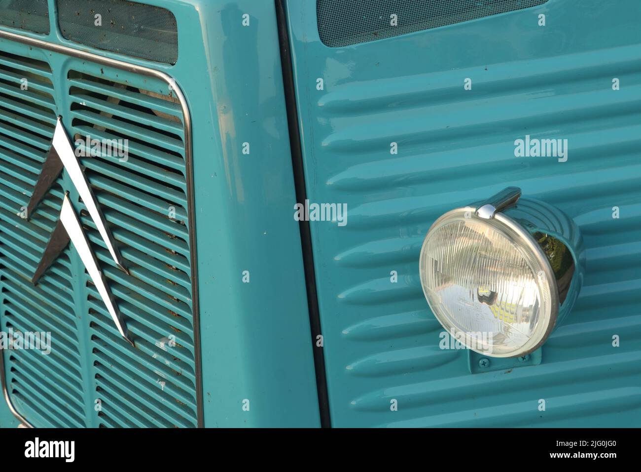 headlight and logo on front of blue Citroën HY van Stock Photo