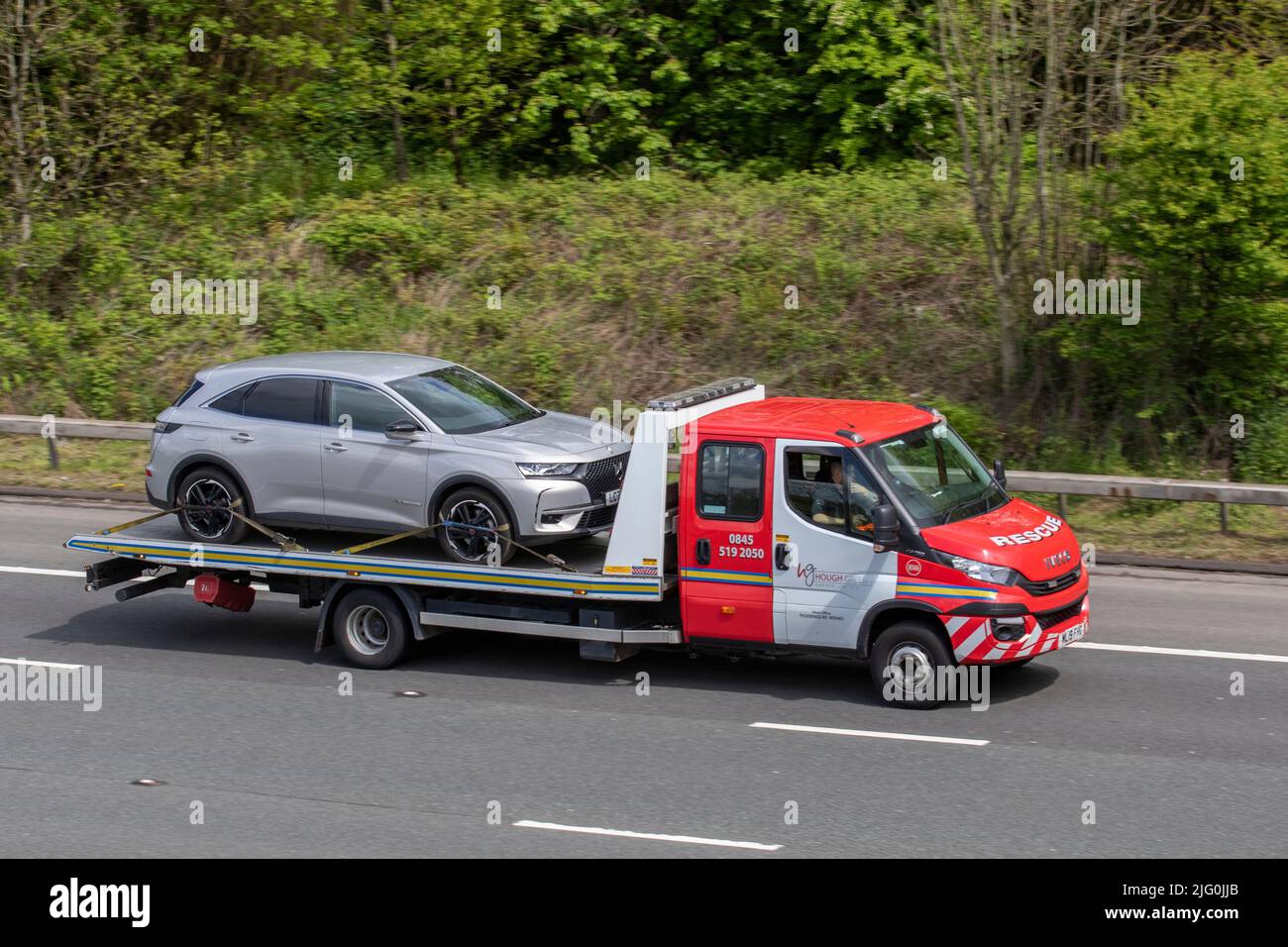 DS Automobiles, DS 3 Crossback Blue HDi 100 Prestige on flat-back 24ht breakdown truck; driving on the M6 Motorway, Manchester, UK Stock Photo