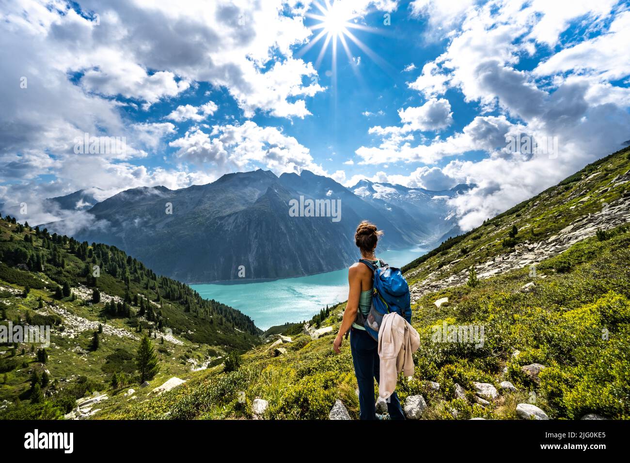 A young tourist traveling in the Schlegeisspeicher glacier reservoir in Zillertal Alps in Austria Stock Photo